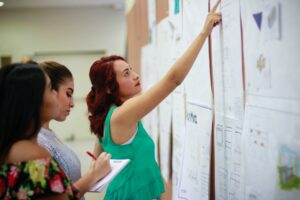 A teacher pointing to a whiteboard